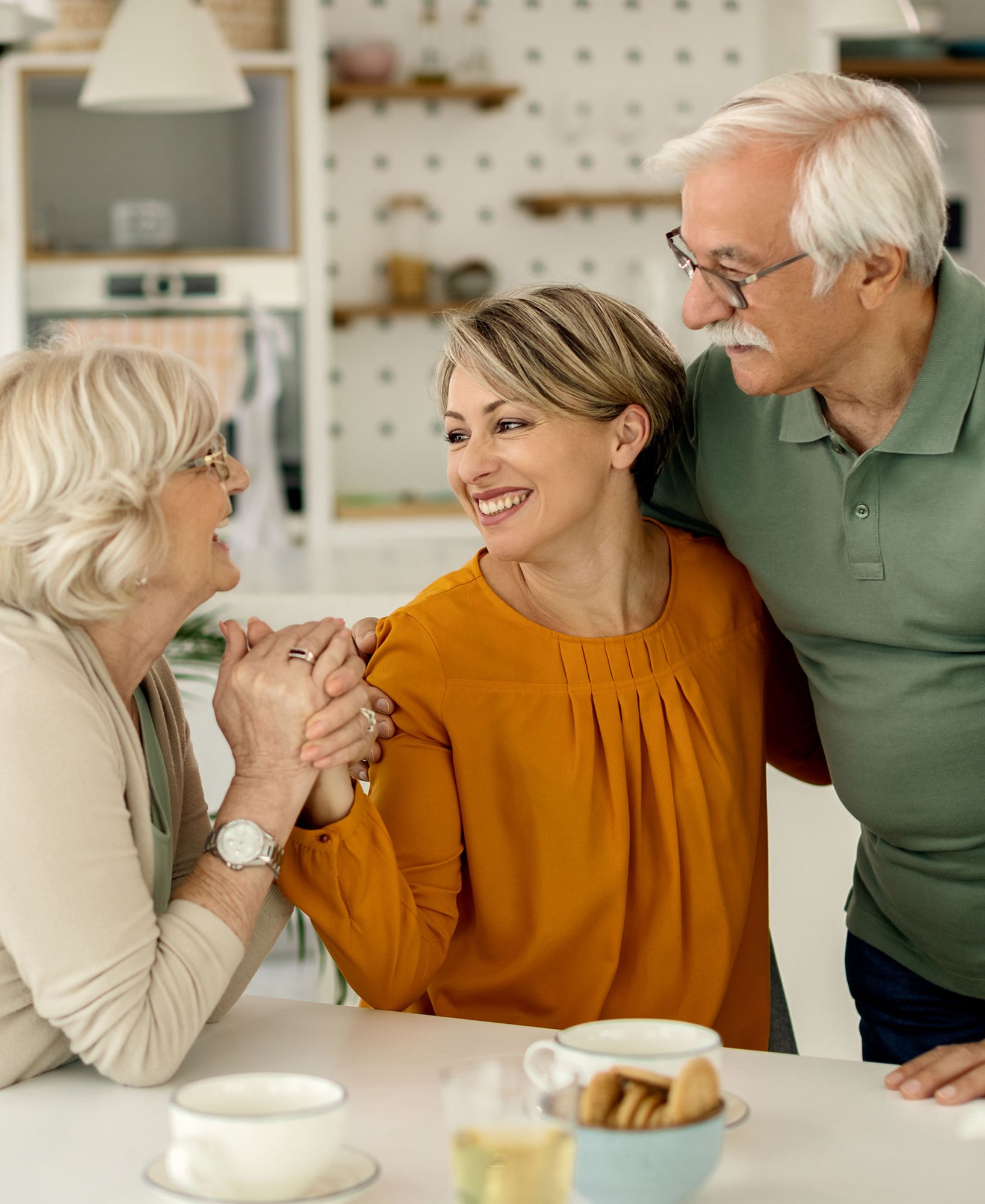 adult-daughter-with-parents-in-kitchen adult-daughter-with-parents-in-kitchen
