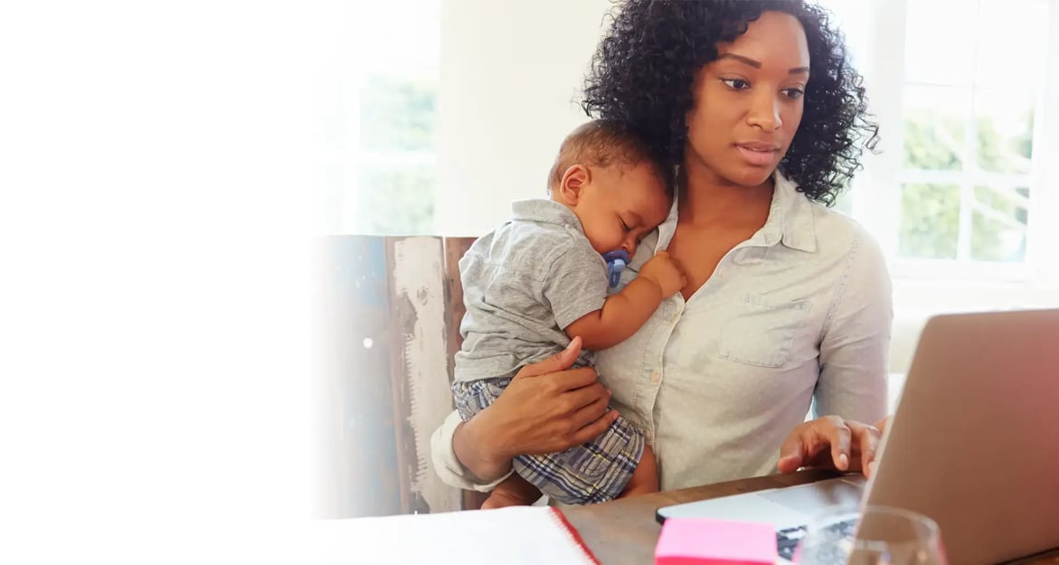 woman with child working on a laptop